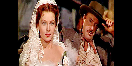 Rhonda Fleming as Madeline Danzeeger with Fred Clark as Basil Danzeeger, crossing paths with Croyden again in The Eagle and the Hawk (1950)
