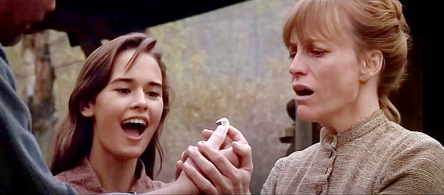 Sydney Penny as Megan Wheeler and Carrie Snodgress as her mother Sarah, reacting to a gold nugget Hull Barret finds in Pale Rider (1985)