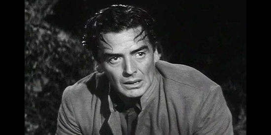 Victor Mature as Ben Lassiter, trying to safely guide his young daughter and two women through Apache war parties in Escort West (1959)