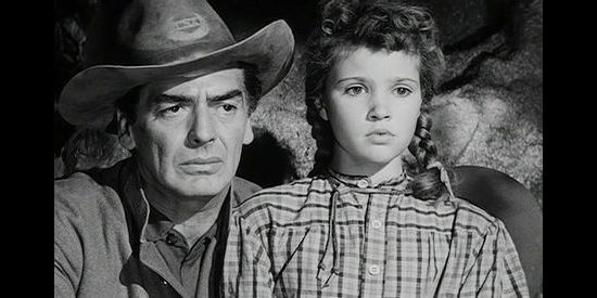 Victor Mature as Ben Lassiter with young daughter Abbey (Reba Waters), pinned down by Apache in Escort West (1959)