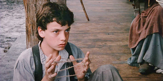 Bryan Fowler as Nathan, Laurie's son, wondering whether or not he can trust newcomer Julian Shaw in Red Headed Stranger (1986)