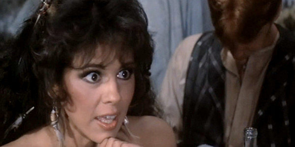 Gina Gallego as Ninfa, the self-proclaimed best french kisser in Chili Verde in Lust in the Dust (1985)