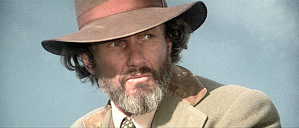 Kris Kristofferson as Jim Averill, witnessing the hardship an immigrant family faces in Heaven's Gate (1980)