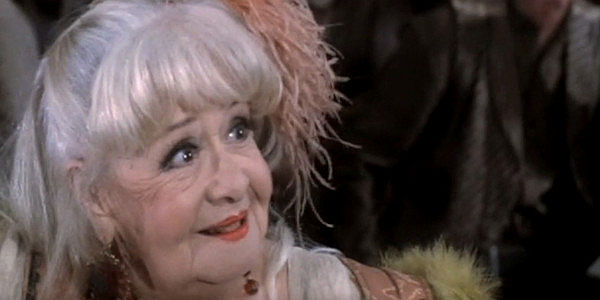 Nedra Volz as Big Ed, the smallest woman in Chili Verde with a big dream of visiting Abilene in Lust in the Dust (1985)