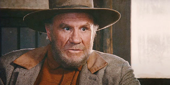 R.G. Armstrong as Reese Scobie, warning Julian Shay about the state of affairs in Driscoll, Montana, in Red Headed Stranger (1986)