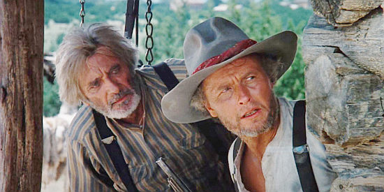 Royal Dano as Larn Claver and Mark Jenkins as his son Victor trying to locate Julian Shay and Reese Scobie in Red Headed Stranger (1986)