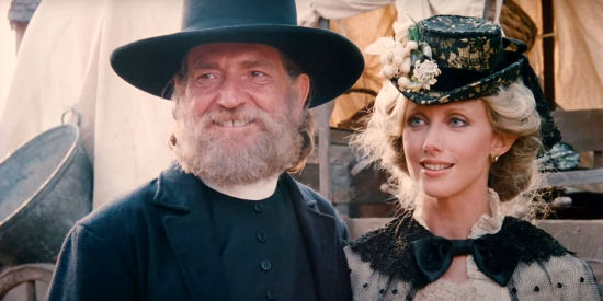 Willie Nelson as Julian Shay and Morgan Fairchild as his wife Raysha, arriving in Driscoll, Montana, in Red Headed Stranger (1986)