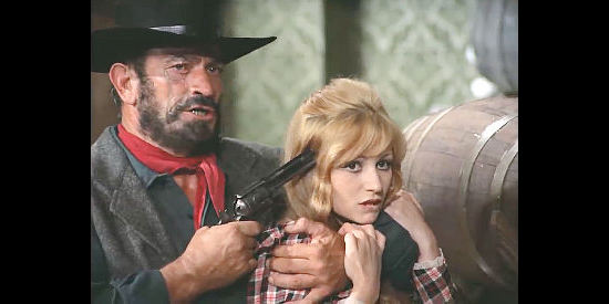 Anna Liberati as Trudy, held at gunpoint in an attempt to get to Sartana in Four Came to Kill Sartana (1969)