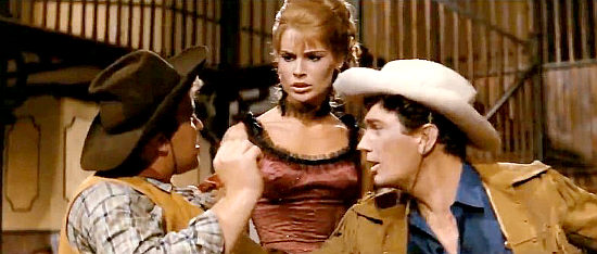Edmund Purdom as Sugar Patterson protects Nelly (Ida Galli as Priscilla Steele) from a rude cowboy in Assault on Fort Texan (1965)