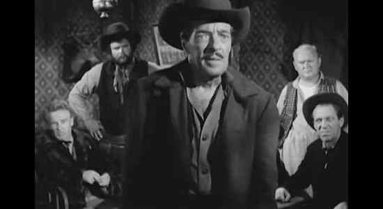 I. Stanford Jolley as Mr. Elliott, trying to bribe Juan Avilla as the other townsmen look on in Terror at Black Falls (1962)