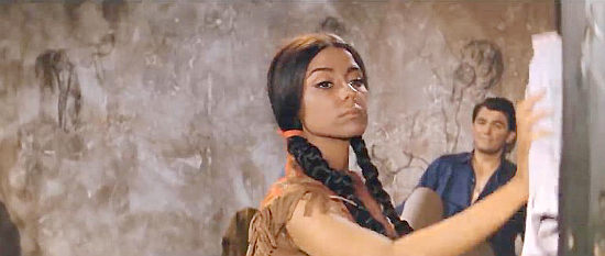 Monica Randall as Anna erasing the erotic artwork of boyfriend Sugar Patterson (Edmund Purdom) in Assault on Fort Texan (1965)