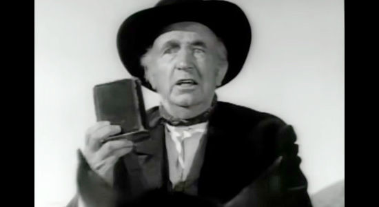 Walter Brennan as Preacher Hawker, displaying his Bible when he meets the Barbees in Shoot Out at Big Sag (1962)