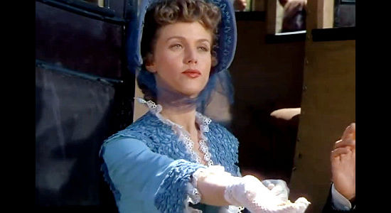 Barbara Britton as Elizabeth Ainsworth, handing her jewels over to bandits in The Raiders (1952)