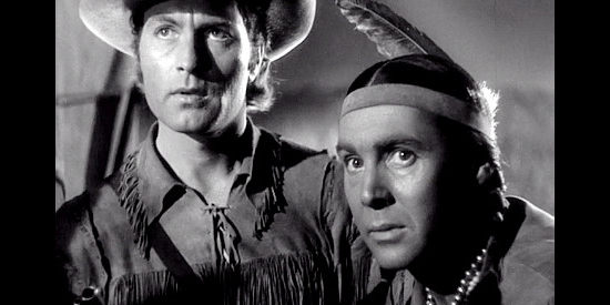 George Montgomery as Davy Crockett and Phillip Reed as Red Hawk, watching and listening for signs of Indian trouble in Davy Crockett, Indian Scout (1950)
