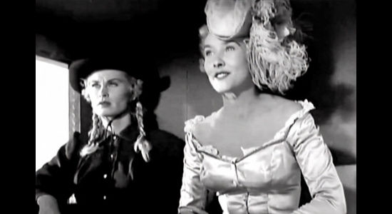 Irish McCalla as 'Big Pearl' Jacksonn and Kathy Marlowe as 'Faro' Kitty Brewster beginning to think of ways to trick the marshal in Five Bold Women (1959)
