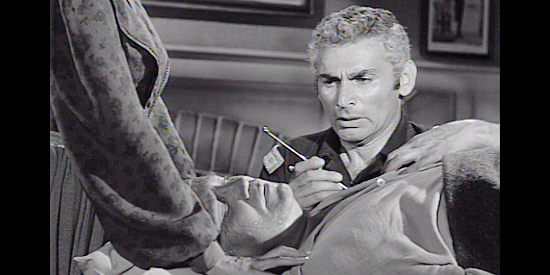 Jeff Chandler as Drango, operating on wounded Dr. Blair (Walter Sande) in Drango (1957)