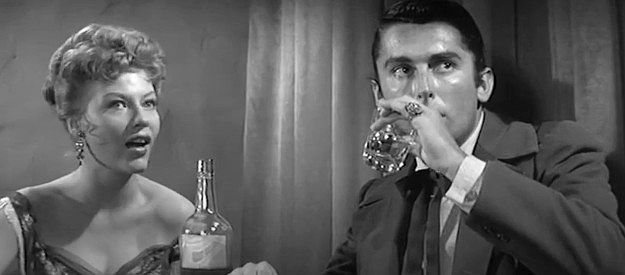 June Blair as a saloon girl wondering what has upset Felix Griffin (Roberts Evans) in The Fiend Who Walked the West (1958)