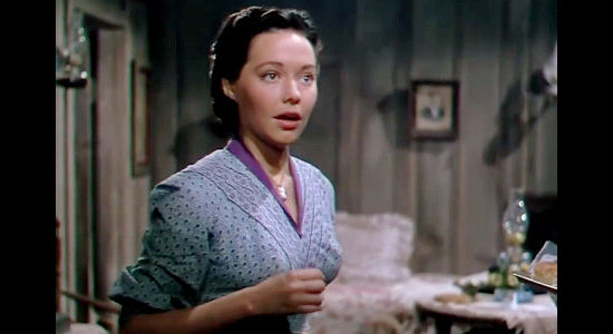 Margaret Field as Mary Morrell, reacting to a stranger at her window in The Raiders (1952)