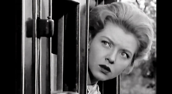 Merry Anders as Ellen Downs, shocked to find husband and outlaw Jim Downs (Jim Ross) show up with plans to help her escape in Five Bold Women (1959)