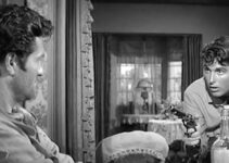 Hugh O'Brian as Daniel Hardy, finding himself facing a gun in the hands of Felix Griffin (Robert Evans) in The Fiend Who Walked the West (1958)