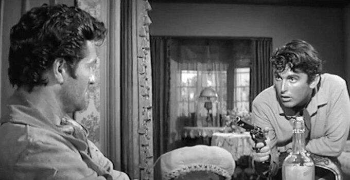 Hugh O'Brian as Daniel Hardy, finding himself facing a gun in the hands of Felix Griffin (Robert Evans) in The Fiend Who Walked the West (1958)