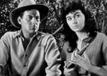 Marla English as Wild Willow, examining the gun Luke Random (John Agar) is seeking the mate to in Flesh and the Spur (1953)