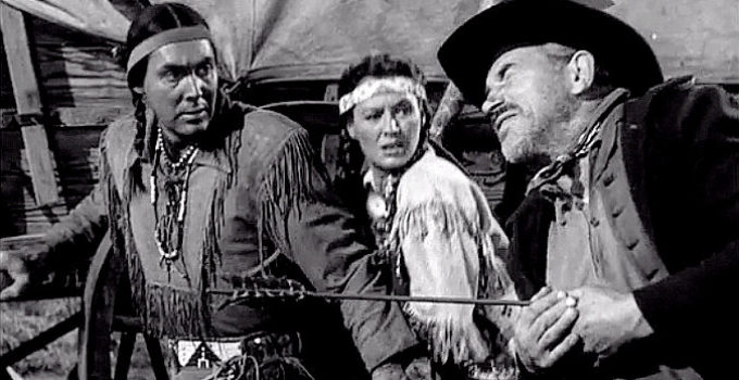 Phillip Reed as Red Hawk and Ellen Drew as Frances Oatman watch a settler take an arrow in Davy Crockett, Indian Scout (1950)