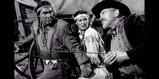 Phillip Reed as Red Hawk and Ellen Drew as Frances Oatman watch a settler take an arrow in Davy Crockett, Indian Scout (1950)