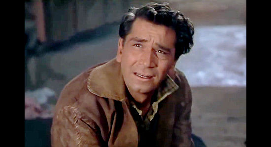 Richard Conte as Jan Morrell, regaining consciousness to find his gold missing and his wife dead in The Raiders (1952)