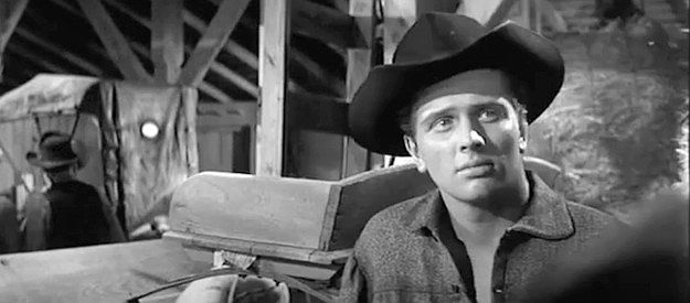 Ron Ely as Deputy Jim Dyer, wondering about his boss's advice not to anger Felix Griffin in The Fiend Who Walked the West I1958)