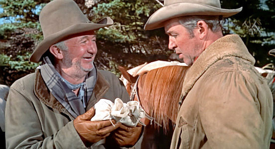 Walter Brennan as Ben Tatum, with his cache of coffee and Jeff Webster (James Stewart) in The Far Country (1954)