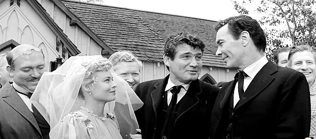 Gene Barry as Wes Bonnell (center) being congratulated on his marraige to Louvenia (Eve Brent) by Griff Bonnell (Barry Sullivan) in Forty Guns (1957)