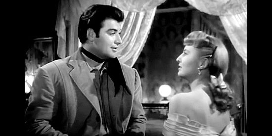 John Bromfield as Clay Jeffords with his sister Vance Jeffords (Barbara Stanwyck), discussing their father in The Furies (1950)