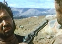 Keith Van Der Wat as Lucky holds a gun on the Major (Beau Brummel) in Three Bullets for a Long Gun (1970)