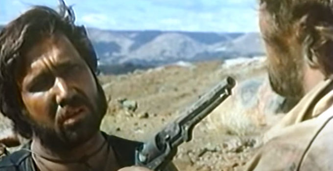 Keith Van Der Wat as Lucky holds a gun on the Major (Beau Brummel) in Three Bullets for a Long Gun (1970)