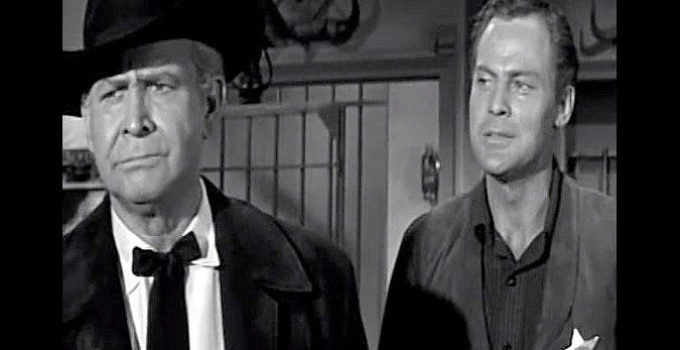 John Agar as JIm Crayle, explaining to his dad (Barton MacLane) why his new job as sheriff of Honcho is so important in Frontier Gun (1958)