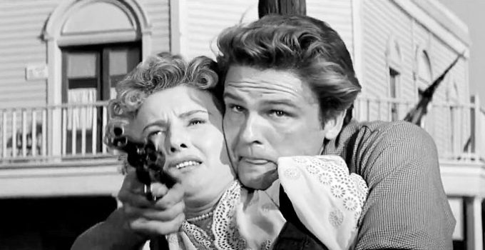 John Ericson as Brockie Drummond with Jessica Drummond (Barbara Stanwyck) in his grip in Forty Guns (1957)