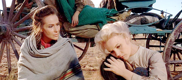 Carroll Baker as Deborah Wright cradles a wounded child while Spanish Woman (Dolores del Rio) looks on in Cheyenne Autumn (1964)