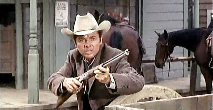 Audie Murphy as Logan Keliher, springing into action when the local bank is being robbed in Bullet for a Badman (1964)