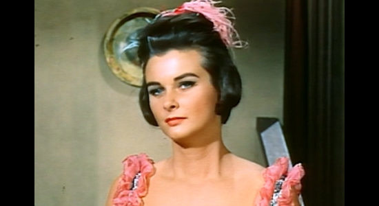 Audrey Dalton as Carole Ridgeway, intrigued by the stranger who walks into the saloon where she works in The Bounty KIller (1965)