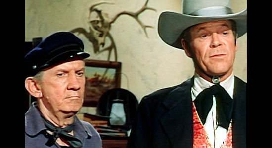 Fuzzy Knight as Capt. Luther and Dan Duryea as Willie Duggans, looking for a list of bounties to collect in The Bounty Killer (1965)