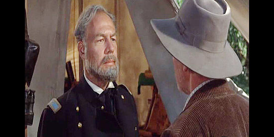 George Kennedy as Col. Fairchild, sympathizing with Charlie Anderson over a son gone missing during the war in Shenandoah (1965)