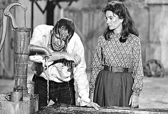 George Peppard as Dolan recovers from a fight while Molly Lang (Jean Simmons) looks on in Rough Night in Jericho (1967)