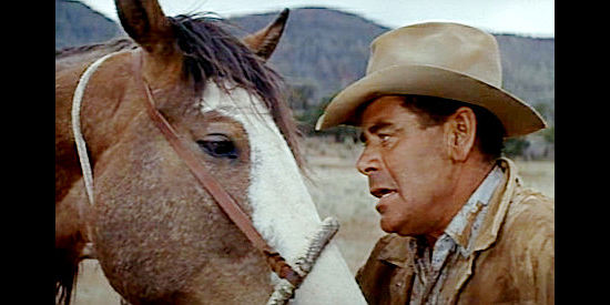 Glenn Ford as Ben Jones, fed up with a misbehaving roan in The Rounders (1965)