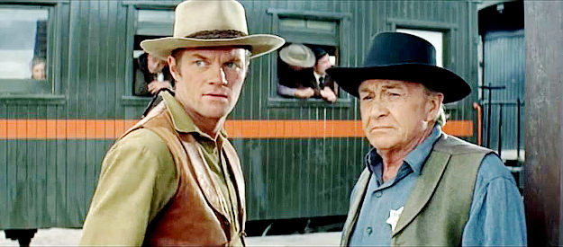 Jeremy Slate as Deputy Ben Latta and Paul Fix as Sheriff Billy Wilson, watching a fast gun arrive in Clearwater in The Sons of Katie Elder (1965)