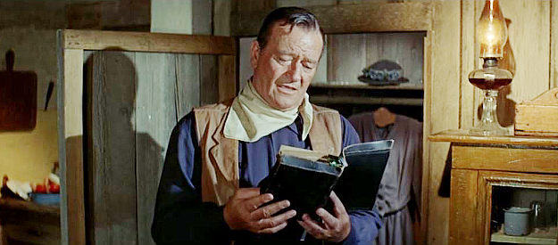 John Wayne as John Elder, reading from his late mother's Bible in The Sons of Katie Elder (1965)