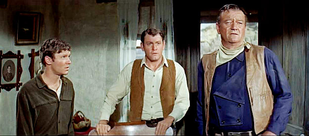 Michael Anderson Jr. as Bud Elder, Earl Holiman as Matt and John Wayne as John Elder debate their next move in The Sons of Katie Elder (1965)