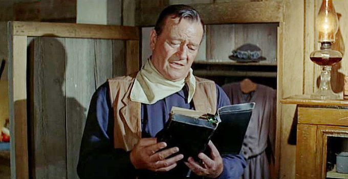 John Wayne as John Elder, reading his late mother's Bible in The Sons of Katie Elder (1965)