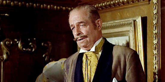 Reginald Denny as Sir Harry Percival, the man who hired Tim Strawn to help his acquire Frank Ballou's ranch in Cat Ballou (1965)