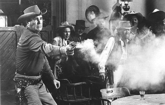 Rod Cameron as Johnny Liam shows off his gun skills in The Bounty Killer (1965)